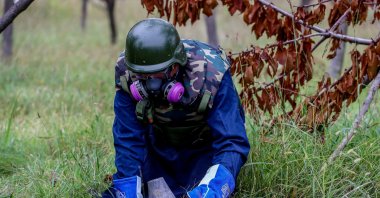 A member of the Azerbaijan National Agency for Mine Action (ANAMA) neutralizes an unexploded ordnance, in Sahlabad village, near Tartar, Azerbaijan, Nov. 4, 2020. (Getty Images Photo)