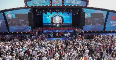 Officials are seen on the stage during the opening ceremony of Türkiye's largest aerospace and technology festival, Teknofest, Adana, southern Türkiye, Oct. 2, 2024. (AA Photo)