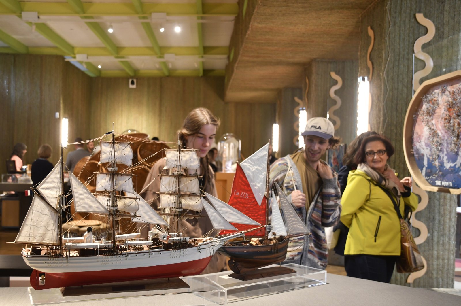 Visitors attend an exhibition of model ships made by the Madagascar company Le Village and on display at the Homo Faber 2024 show, Venice, Italy, Sept. 13, 2024. (AP Photo)