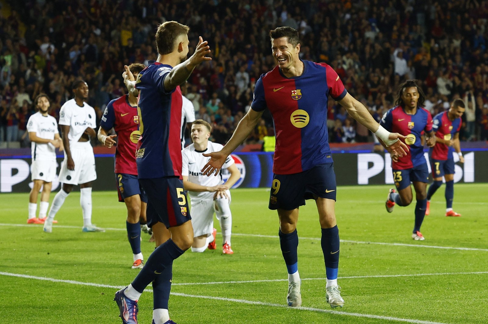 FC Barcelona&#039;s Robert Lewandowski (R) celebrates with Inigo Martinez after scoring during the Champions League match against Young Boys at the Estadi Olimpic Lluis Companys, Barcelona, Spain, Oct. 1, 2024. (Reuters Photo) 