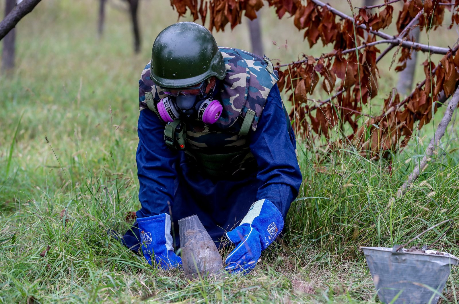 A member of the Azerbaijan National Agency for Mine Action (ANAMA) neutralizes an unexploded ordnance, in Sahlabad village, near Tartar, Azerbaijan, Nov. 4, 2020. (Getty Images Photo)