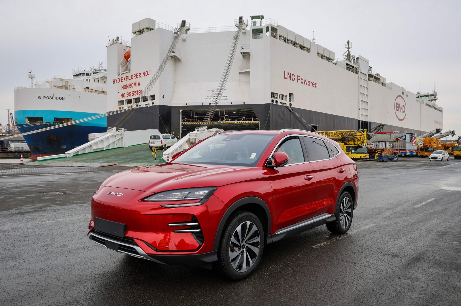 An electric car by Chinese car manufacturer BYD is parked in front of a carrier ship, Bremerhaven, Germany, Feb. 26, 2024. (AFP Photo)