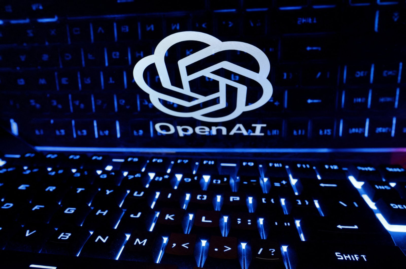 A keyboard is placed in front of a displayed OpenAI logo in this illustration taken on Feb. 21, 2023. (Reuters Photo)