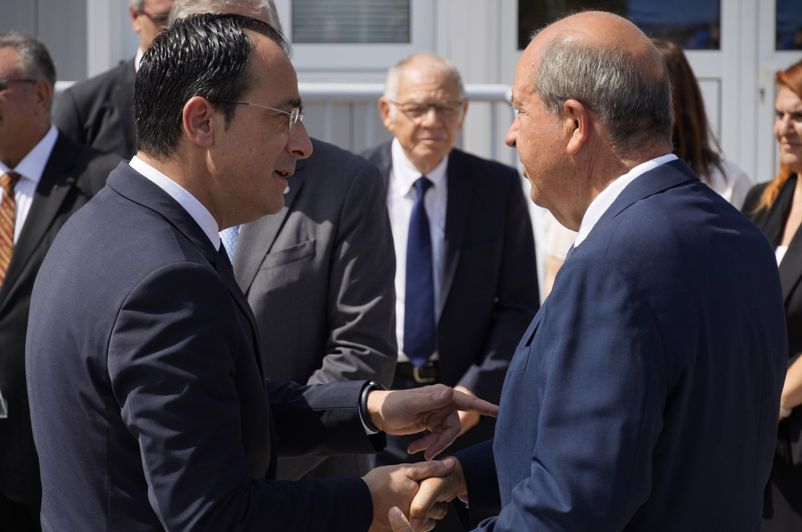 Turkish Cypriot President Ersin Tatar (R) and Greek Cypriot administration leader Nikos Christodoulides shake hands during a visit to the anthropological laboratory of the Committee on Missing Persons, Lefkoşa (Nicosia), July 28, 2023. (AP Photo)