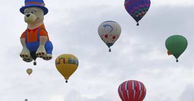 A special shaped hot air balloon flies among others during the 44th International Balloon Fiesta in Albuquerque, New Mexico, U.S., Oct. 4, 2015. (AP Photo)