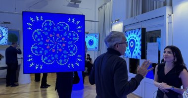 Artwork and visitors at the "Symbol of Dances" exhibition, Vienna, Austria, Oct. 3, 2024. (AA Photo)
