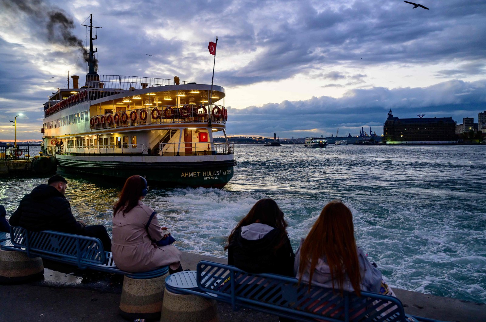 People watch as a ferry departs from the Kadiköy pier at sunset, Istanbul, Türkiye, Sept. 30, 2024. (AFP Photo)