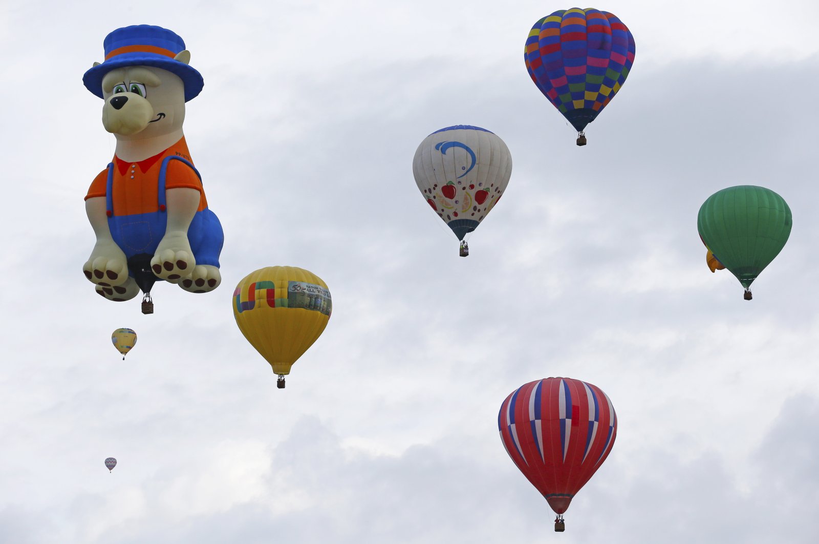 A special shaped hot air balloon flies among others during the 44th International Balloon Fiesta in Albuquerque, New Mexico, U.S., Oct. 4, 2015. (AP Photo)