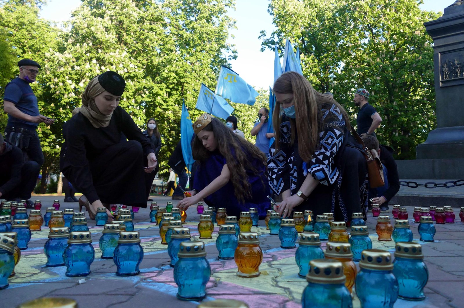 People arrange vigil lanterns at the Mikhail Vorontsov monument in memory of the victims of the deportation of Crimean Tatars which began on May 18, 1944, Odesa, southern Ukraine, May 18, 2020. (Getty Images Photo)