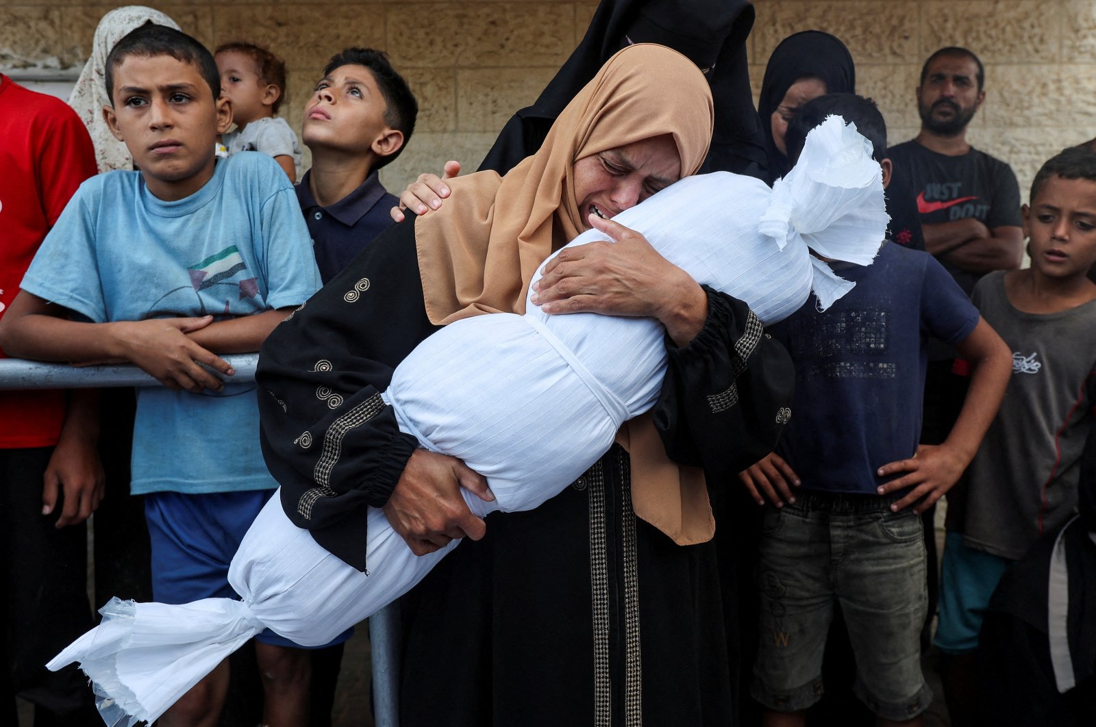 A relative holds the body of a Palestinian child from the al-Durrah family, who was killed in an Israeli strike at Al-Aqsa Martyrs Hospital in Deir Al-Balah, Gaza Strip, Palestine, Oct. 1, 2024. (Reuters Photo)