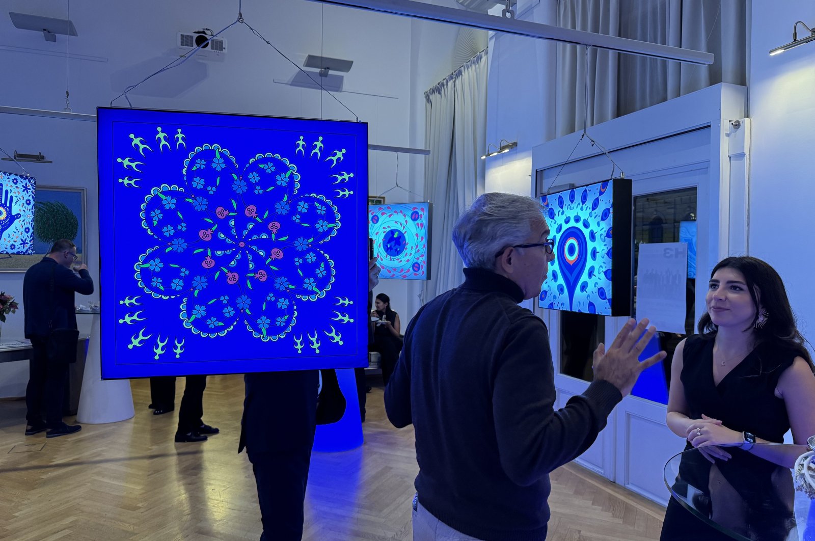 Artwork and visitors at the &quot;Symbol of Dances&quot; exhibition, Vienna, Austria, Oct. 3, 2024. (AA Photo)