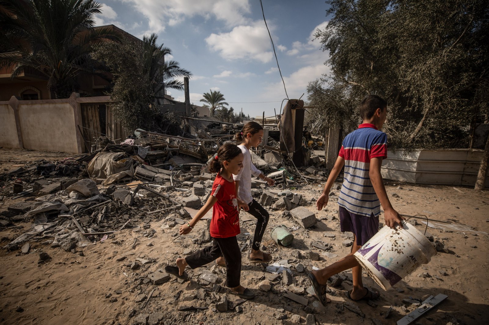 A group of Palestinian children walk past the rubble of a destroyed building following an Israeli airstrike in Deir Al Balah, central Gaza Strip, Palestine, Oct. 4, 2024. (EPA Photo)