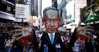 People hold an image of Prime Minister of Israel Benjamin Netanyahu with blood on his face as they demonstrate to mark one year of Israel&#039;s attacks on Gaza, New York, U.S., Oct. 5, 2024. (AFP Photo)