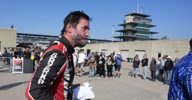 Keanu Reeves walks in the garage area following a GR Cup Series auto race at Indianapolis Motor Speedway, Indianapolis, U.S., Oct. 5, 2024. (AP Photo)