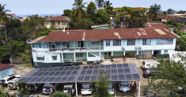 This photo released by Easy Solar shows a large solar panels installation on a rooftop of an office building in Freetown, Sierra Leone, Aug. 13, 2024. (AP Photo)