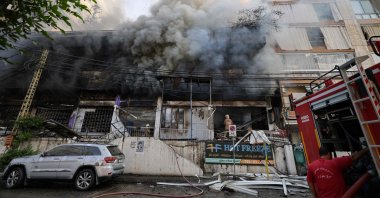 First responders fight the blaze inside a building set on fire by an Israeli strike that targeted Beirut’s southern suburbs, Lebanon, Oct. 6, 2024. (AFP Photo)