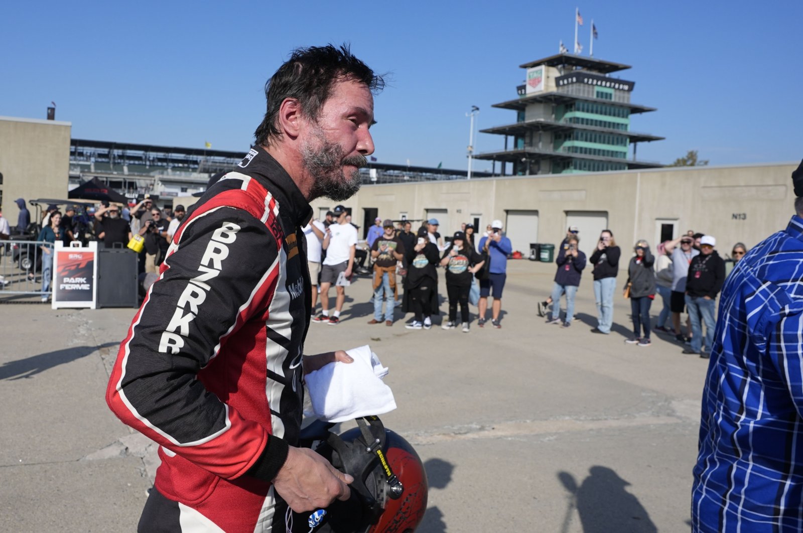 Keanu Reeves walks in the garage area following a GR Cup Series auto race at Indianapolis Motor Speedway, Indianapolis, U.S., Oct. 5, 2024. (AP Photo)