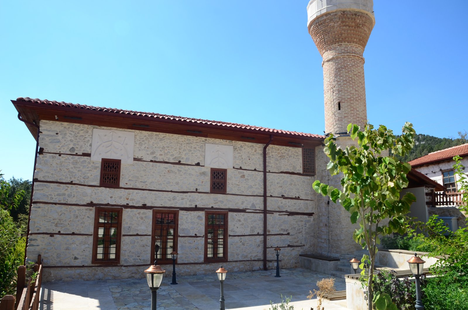 The exterior of the 600-year-old Sarıhacılar Mosque showcases its historical architectural design, Antalya, Türkiye, Oct. 6, 2024. (IHA Photo) 