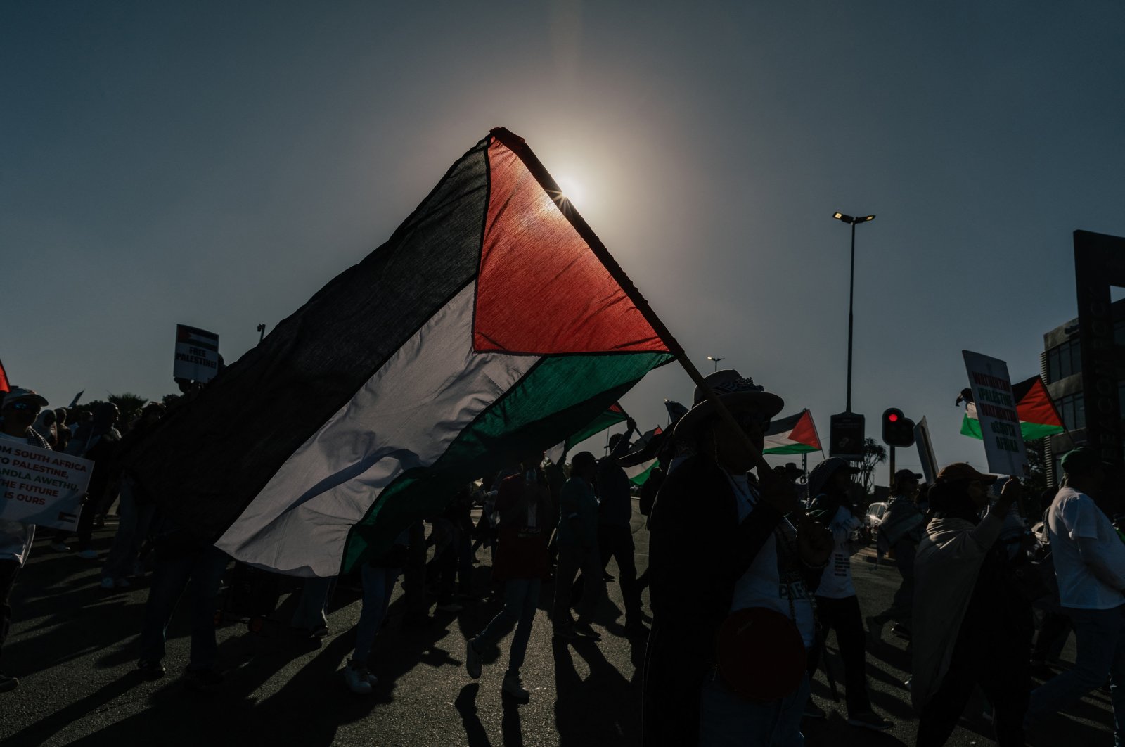 Pro-Palestinian activists hold placards and wave Palestinian flags during a march against Israel&#039;s attacks, Durban, South Africa, Oct. 5, 2024. (AFP Photo)