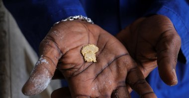 A worker displays a gold nugget inside a smelting facility in Accra, Ghana, Aug. 22, 2024. (Reuters Photo)