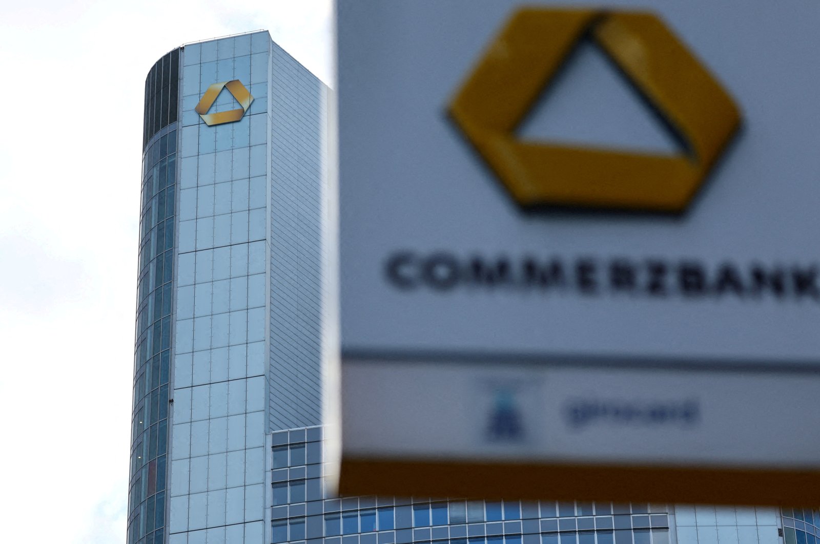 A logo of the bank is seen next to the headquarters of Commerzbank one day ahead of the bank&#039;s rejoinment to Germany&#039;s share price index DAX in Frankfurt, Germany, Feb. 26, 2023. (Reuters Photo)