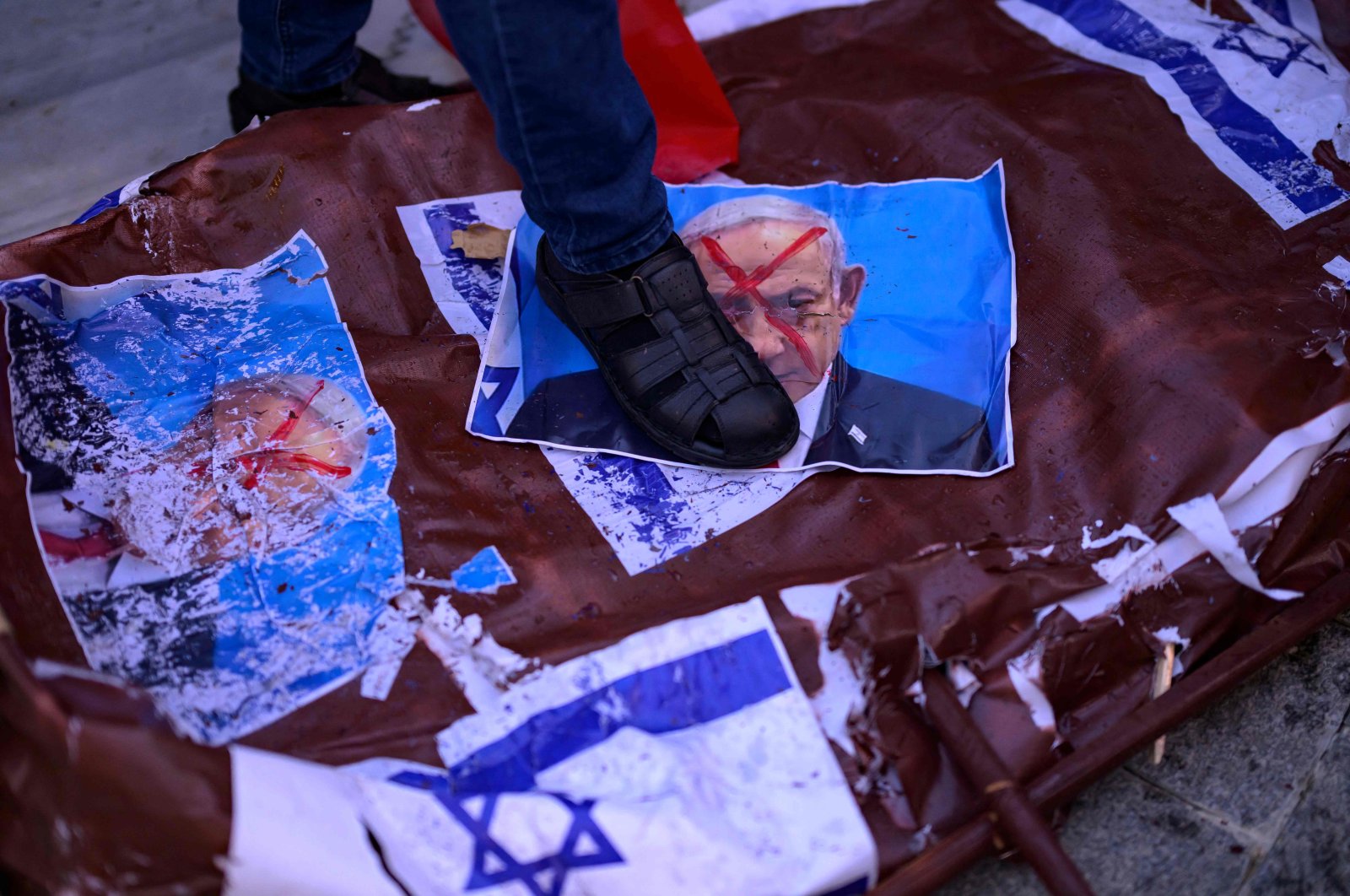 A protester steps on a picture of Israel&#039;s Prime Minister Benjamin Netanyahu during a rally on the eve of the anniversary of the Oct. 7 Hamas attack, at the Beyazıt Square, Istanbul, Türkiye, Oct.  6, 2024. (AFP Photo)