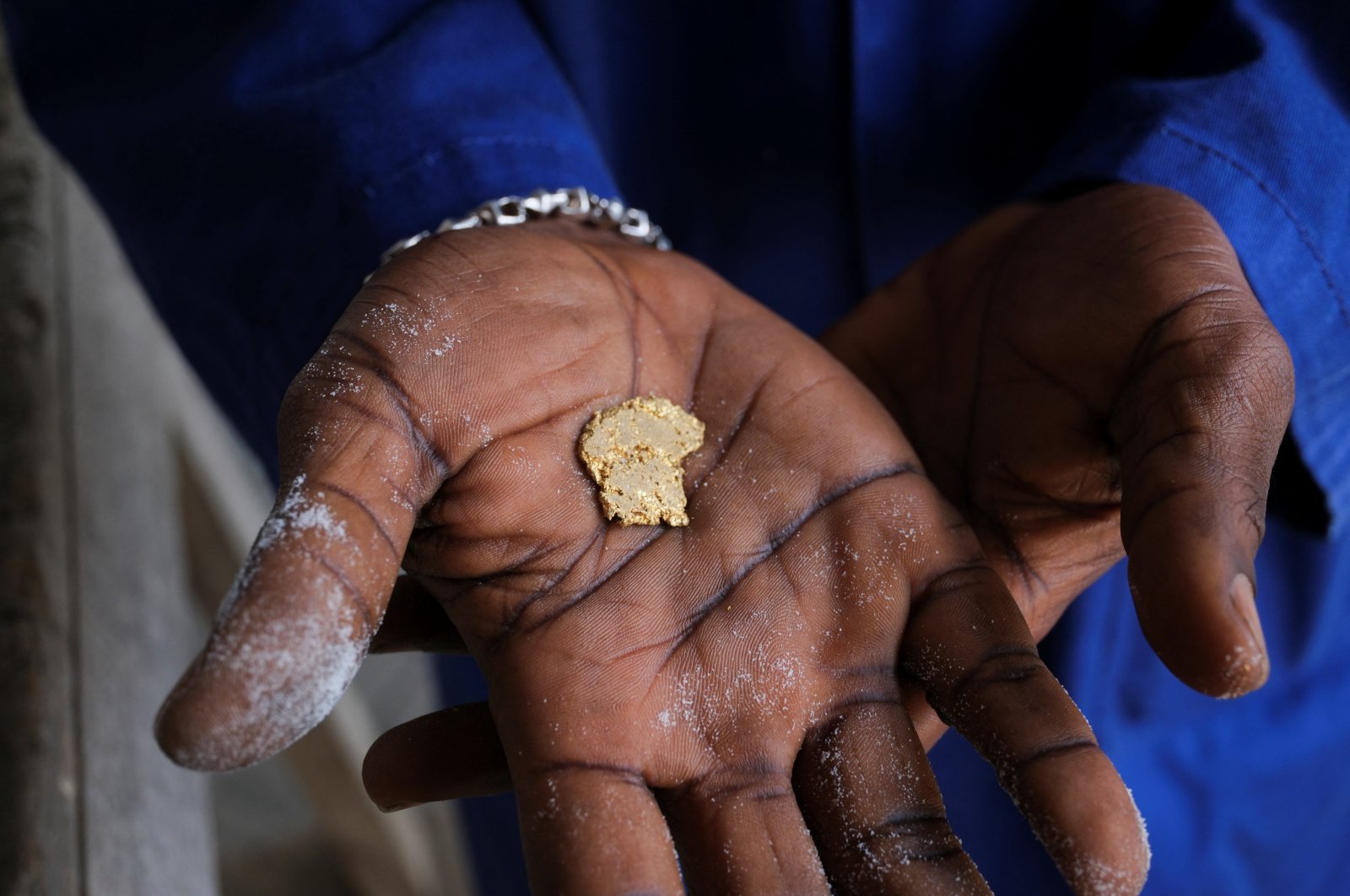 A worker displays a gold nugget inside a smelting facility in Accra, Ghana, Aug. 22, 2024. (Reuters Photo)