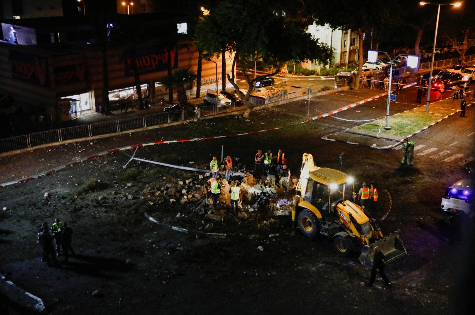 Israeli rescuers inspect the site where a projectile fell, amid cross-border hostilities with Hezbollah, in Haifa, northern Israel, Oct. 7, 2024. (Reuters Photo)