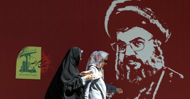 Iranian women walk past a portrait of late Hezbollah leader Hassan Nasrallah displayed in a street, Tehran, Iran, Oct. 7, 2024. (EPA Photo)