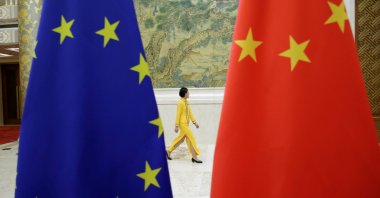 An attendant walks past EU and China flags ahead of the EU-China High-level Economic Dialogue at Diaoyutai State Guesthouse, Beijing, China, June 25, 2018. (Reuters Photo)
