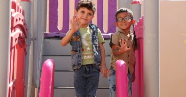 Children wave at a ceremony for the opening of the 1071 Sultan Alparslan Kindergarten in Ras al-Ain, Syria, Sept. 21, 2022 (AA Photo)