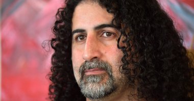 Saudi painter Omar bin Laden, the fourth-eldest son of former al-Qaida leader Osama Bin Laden, poses during an exhibition of some thirty of his artworks at the "Arielle Brocante" in Le Teilleul, western France, July 1, 2022. (AFP File Photo)