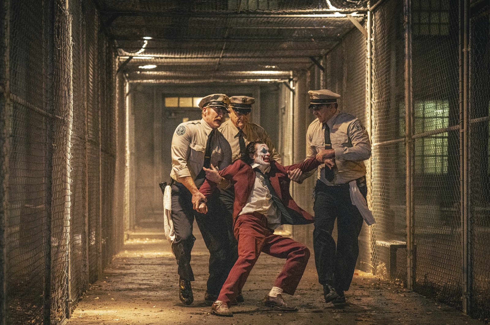 Joaquin Phoenix (foreground C) and Brendan Gleeson (background C) in a scene from &quot;Joker: Folie a Deux.&quot; (Warner Bros. via AP Photo)