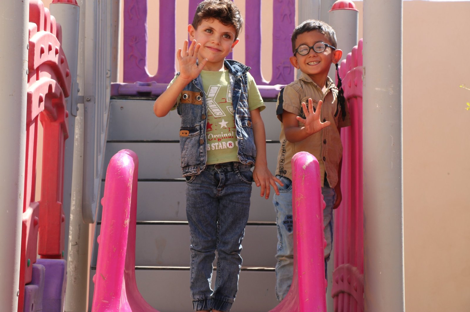 Children wave at a ceremony for the opening of the 1071 Sultan Alparslan Kindergarten in Ras al-Ain, Syria, Sept. 21, 2022 (AA Photo)