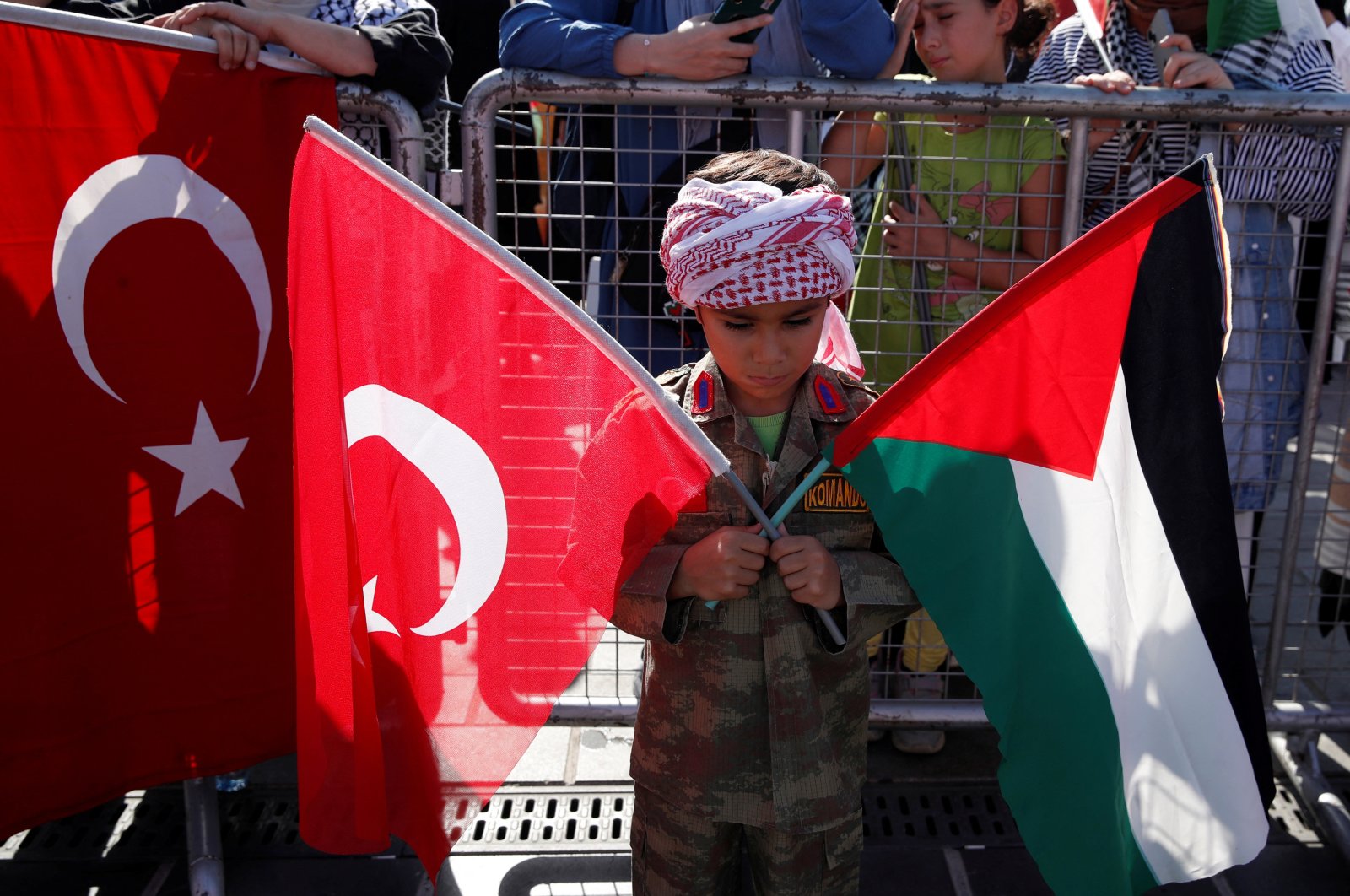 A boy holds Turkish and Palestinian flags during a protest to express support for Palestinians in Gaza, Istanbul, Türkiye, Oct. 6, 2024. (Reuters Photo)