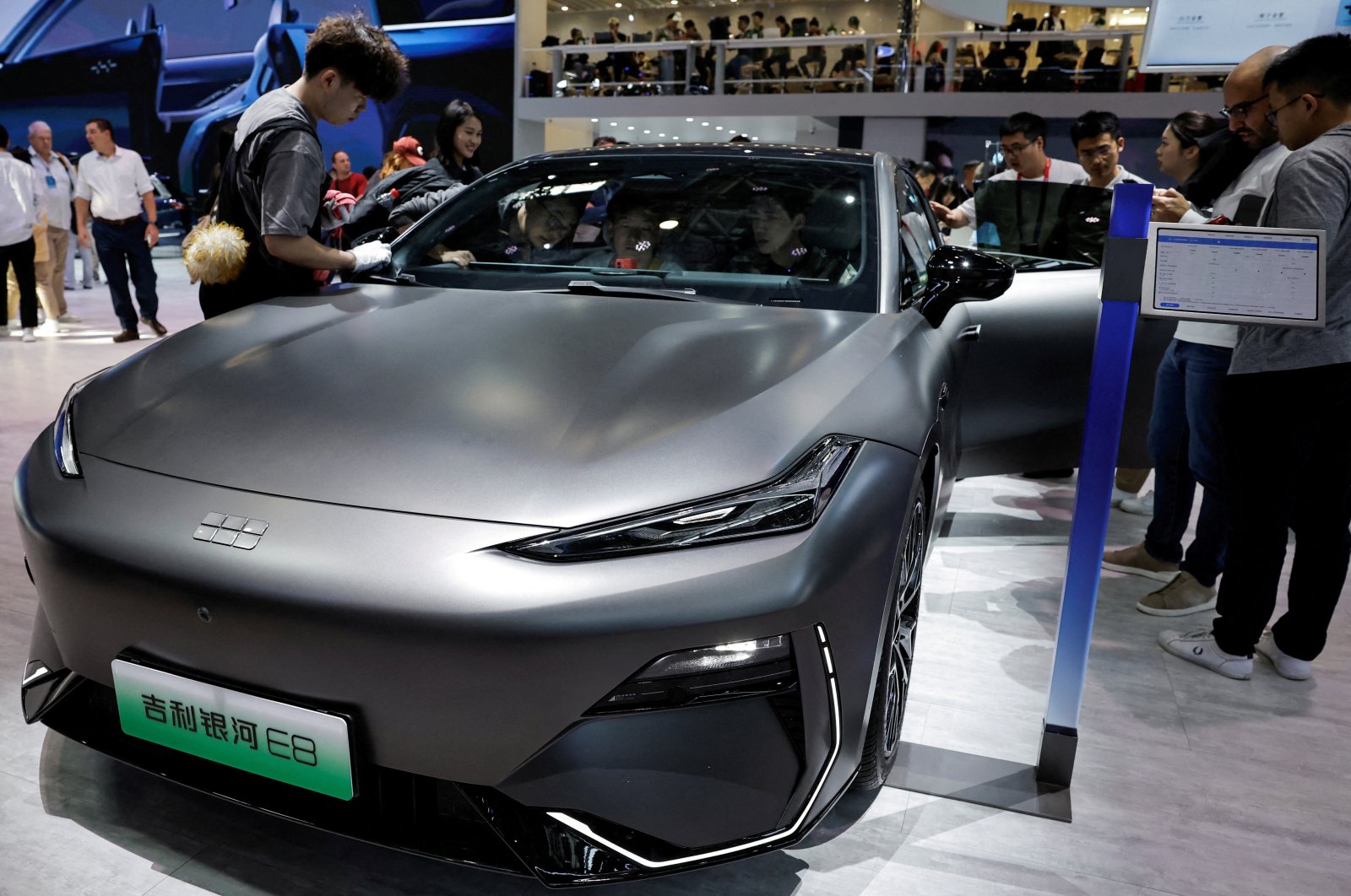 A staff member cleans the Geely Galaxy E8 electric vehicle at the Beijing International Automotive Exhibition, or Auto China 2024, Beijing, China, April 25, 2024. (Reuters Photo)