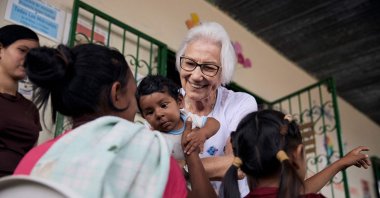 Sister Rosita Milesi holds baby Daniel Jose Milaro, who has just arrived from Venezuela with his mother, Jenifer Milaro and siblings, at the Casa de Acolhida Sao Jose, a temporary shelter for refugees and migrants in Pacaraima, Brazil, Aug. 24, 2024. (AFP Photo)