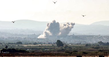 Birds fly away as a smoke cloud erupts following an Israeli airstrike on a village near the southern city of Tyre, Lebanon, Oct. 9, 2024. (AFP Photo)