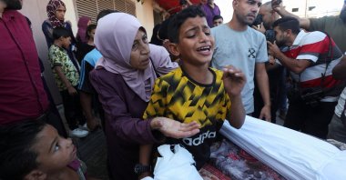 A boy mourns near the body of his father and other Palestinians, who were killed in an Israeli strike at the Al-Aqsa Martyrs Hospital in Deir Al-Balah, central Gaza Strip, Palestine, Oct. 9, 2024. (Reuters Photo)