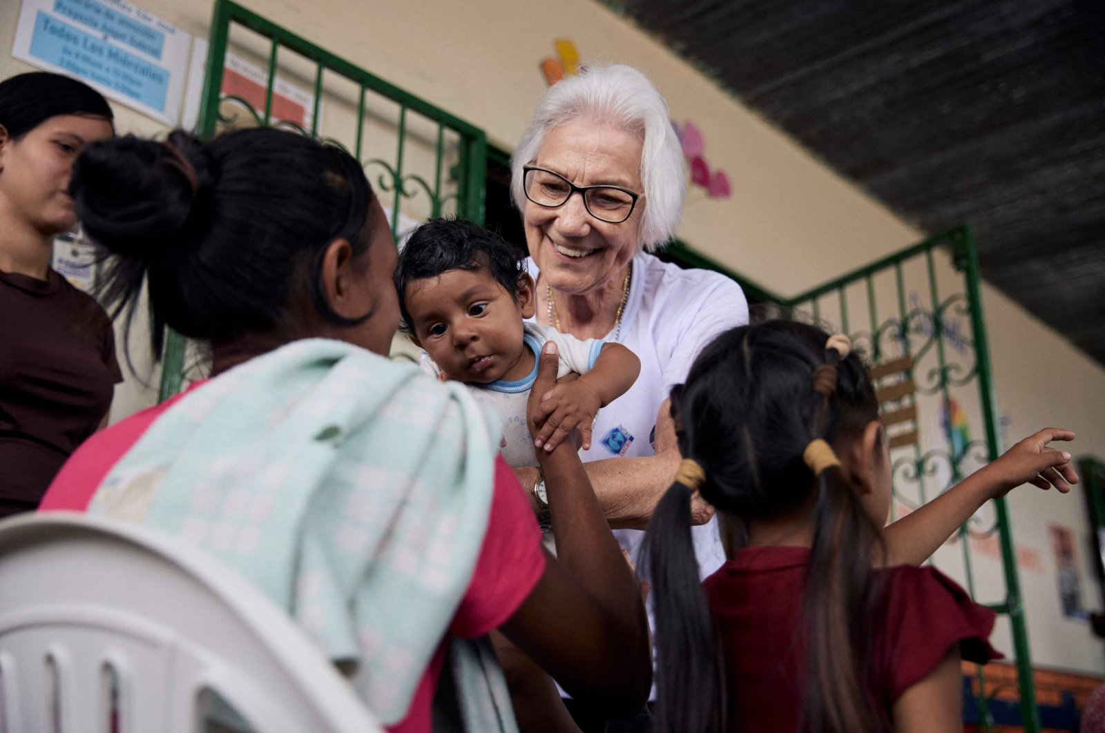 Sister Rosita Milesi holds baby Daniel Jose Milaro, who has just arrived from Venezuela with his mother, Jenifer Milaro and siblings, at the Casa de Acolhida Sao Jose, a temporary shelter for refugees and migrants in Pacaraima, Brazil, Aug. 24, 2024. (AFP Photo)