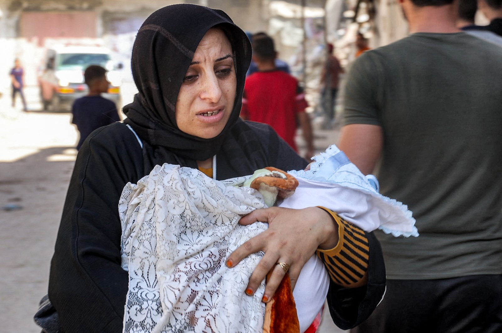 An evacuating woman walks carrying an infant child in the Jabalia camp in the northern Gaza Strip, Palestine, Oct. 9, 2024. (AFP Photo)