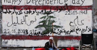 A displaced woman looks on next to her makeshift encampment on the street at Beirut&#039;s central Martyrs&#039; Square, where many families spent the night while fleeing the overnight Israeli strikes in southern Beirut, Lebanon, Oct. 9, 2024. (Reuters Photo)