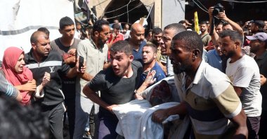 Palestinians carry an injured person after an Israeli strike hit the Rafida school sheltering displaced people in Deir al-Balah, central Gaza Strip, Palestine, Oct. 10, 2024. (AFP Photo)
