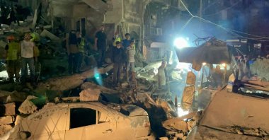 Lebanese civil defense members and other people inspect the site of an Israeli airstrike on the Basta neighborhood of Beirut, Oct.10, 2024. (AFP Photo)