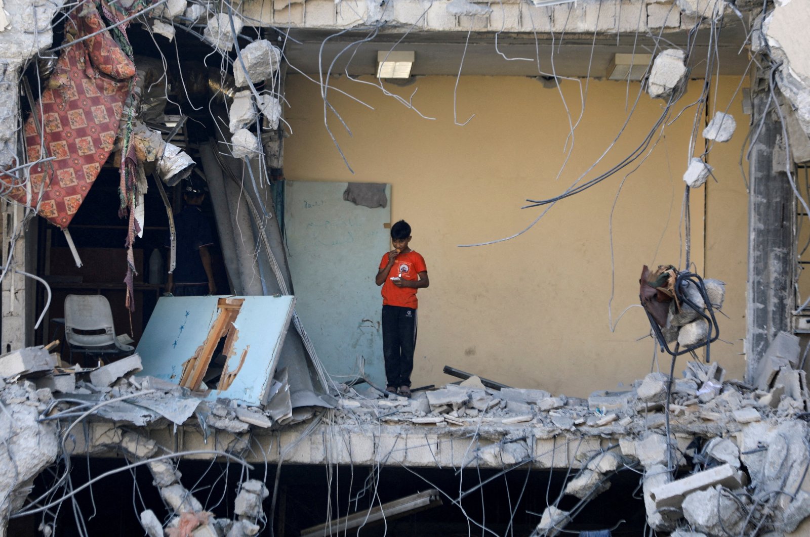 A Palestinian boy stands among rubble in Gaza City, Palestine, July 12, 2024. (Reuters Photo)