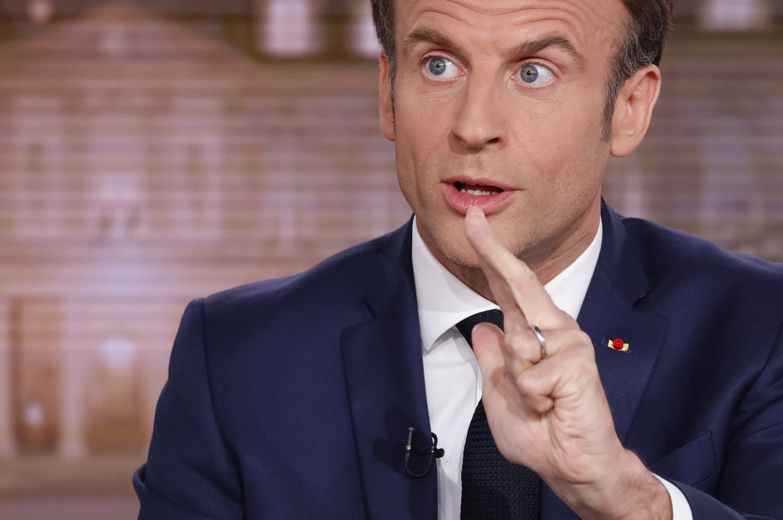 French President Emmanuel Macron gestures during the evening news broadcast of French TV channel TF1, in Boulogne-Billancourt, outside Paris, Wednesday, April 13, 2022. (AP File Photo)