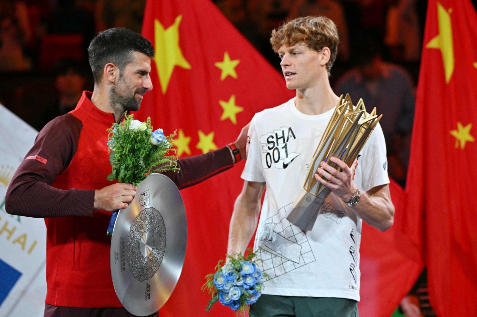 Italy&#039;s Jannik Sinner (R) is greeted by Serbia’s Novak Djokovic on winning the Shanghai Masters, Shanghai, China, Oct. 13, 2024. (AFP Photo)