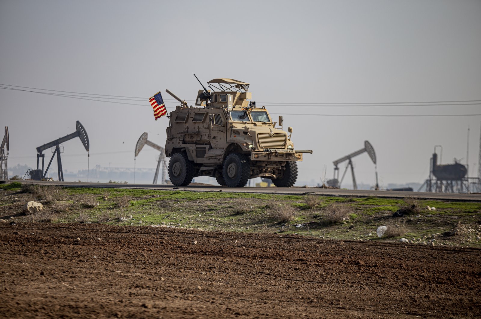 A U.S. military vehicle is seen on a patrol in the countryside near the town of Qamishli, Syria, Dec. 4, 2022. (AP Photo) 