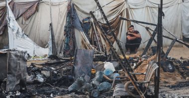 A Palestinian man looks on next to the damage at the site of an Israeli strike on tents sheltering displaced people at Al-Aqsa Martyrs hospital in Deir Al-Balah, in the central Gaza Strip, Palestine, Oct. 14, 2024. (Reuters Photo)