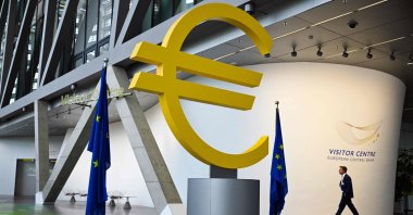 A man walks past a giant Euro logo at the visitor center of the European Central Bank (ECB) headquarters, Frankfurt, Germany, July 18, 2024. (AFP Photo)